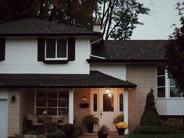 Exterior of a home with porch lights on